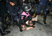 20 Arrested During the Crackdown Near Grand Palace, Reporters Hit by Rubber Bullets Police arrest a man during a protest at Sanam Luang on Mar. 20, 2021.