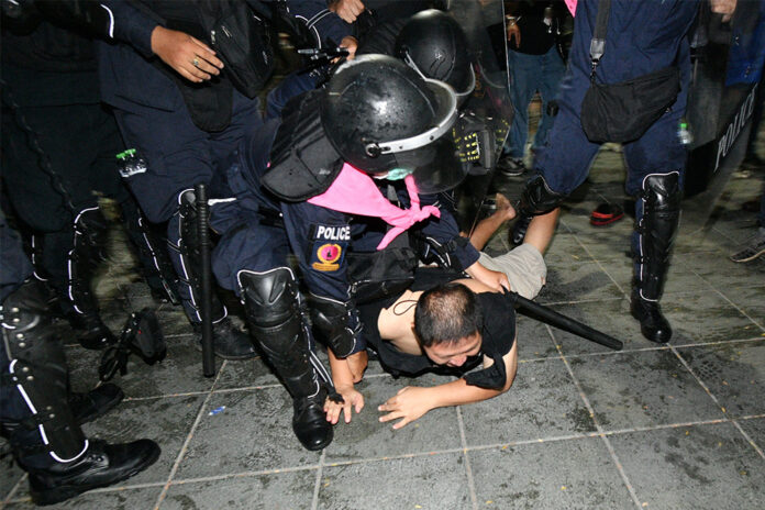 Police arrest a man during a protest at Sanam Luang on Mar. 20, 2021. Police arrest a man during a protest at Sanam Luang on Mar. 20, 2021.