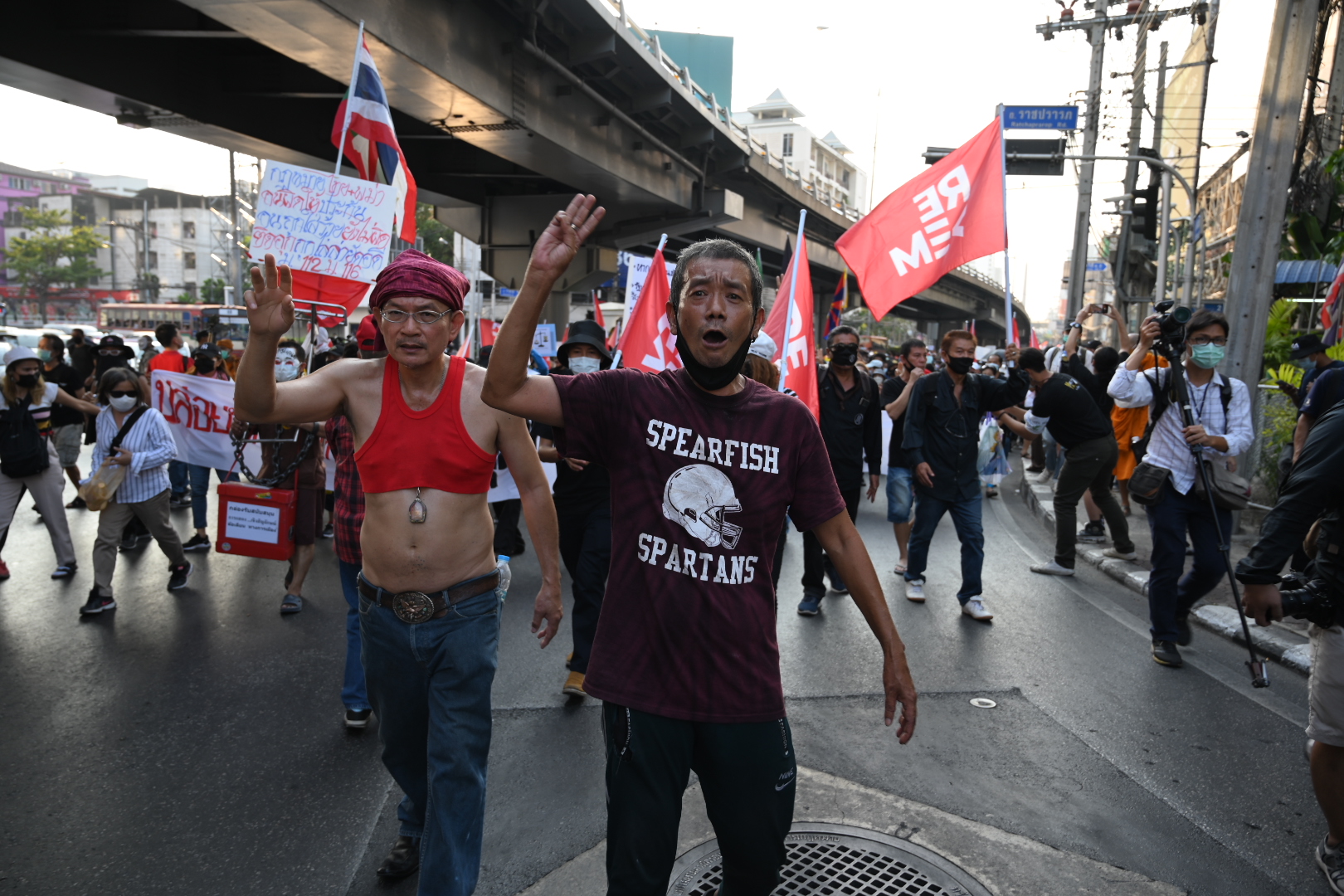 A demonstrator flashes the three-finger salute during the march to PM Prayut Chan-o-cha's residence on Feb. 28, 2021.