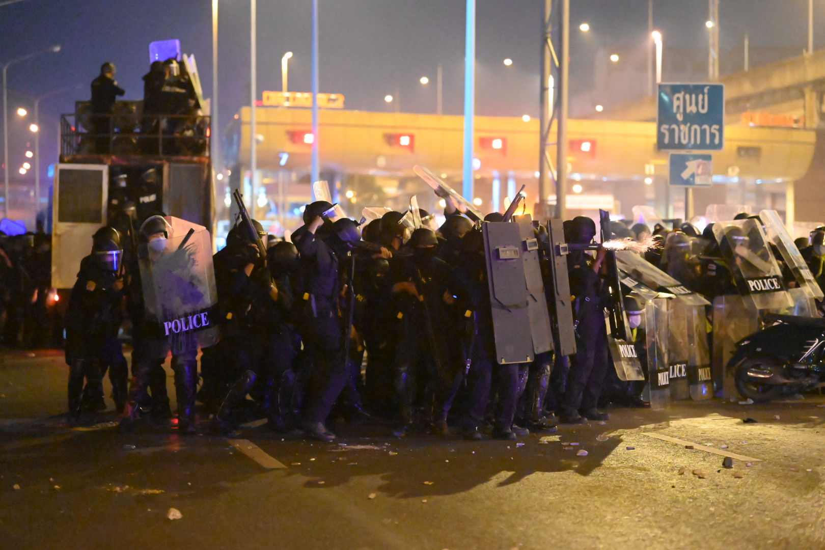 A riot police fires rubber bullets at anti-government demonstrators in front of the 1st Infantry Regiment army base on Feb. 28, 2021.