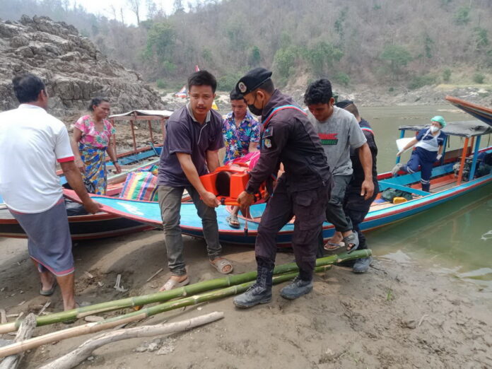 An injured Karen villager from Myanmar is transported across the border to a hospital on the Thai side in Mae Hong Son province on March 30, 2021.