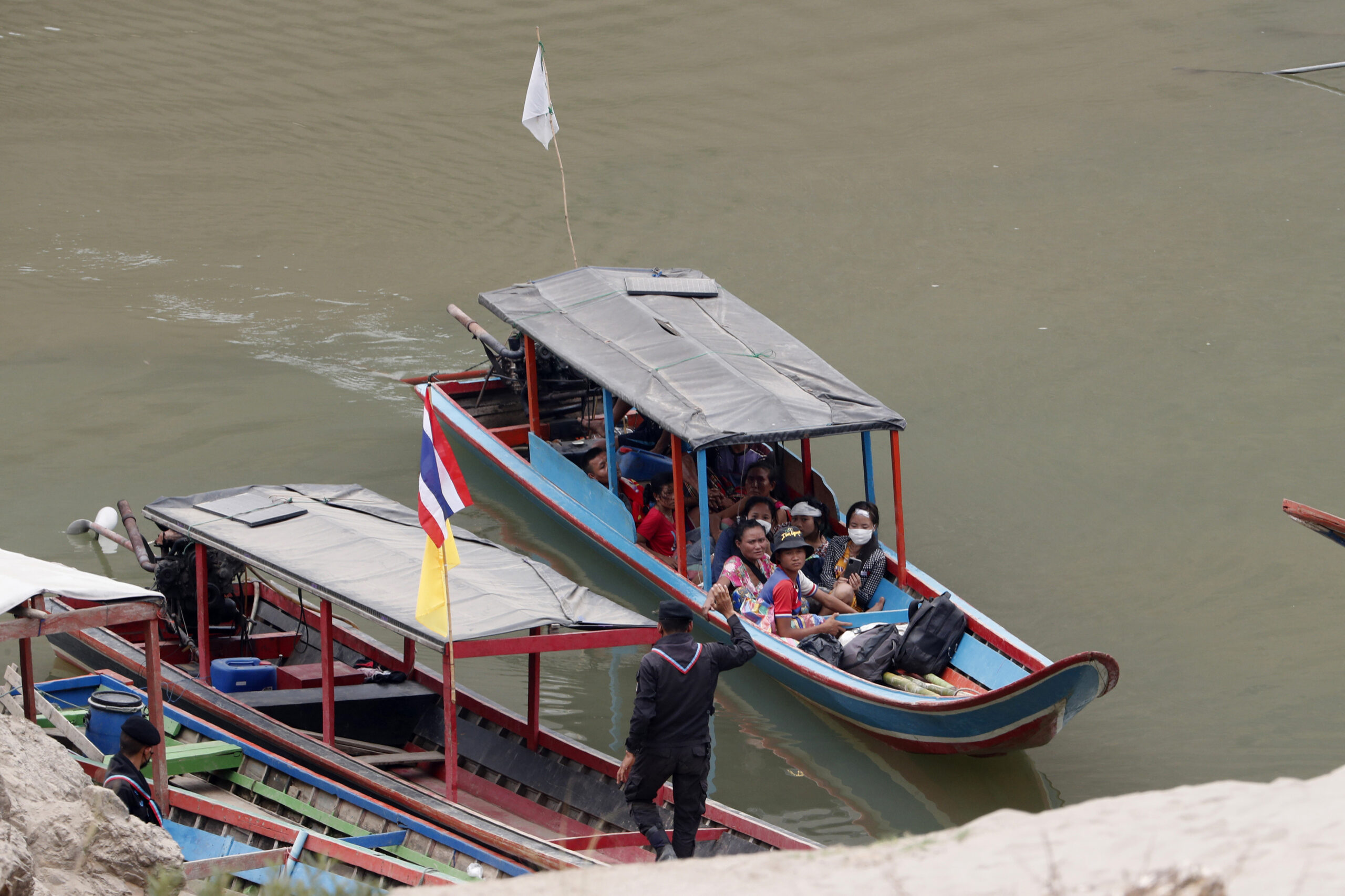 In this March 30, 2021, file photo, Karenni villagers from Myanmar arrive on a boat with an injured person as they evacuate to Ban Mae Sam Laep Health Center in Mae Hong Son province, northern Thailand. Photo: Sakchai Lalit / AP File