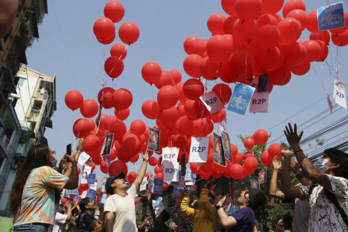 FILE - In this March 22, 2021, file photo, anti-coup protesters release red balloons with notes calling for foreign intervention to help them in Yangon, Myanmar. Photo: AP File
