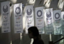 North Korea Says It Won’t Participate in Tokyo Olympics A woman wearing a protective mask to help curb the spread of the coronavirus walks near banners for Tokyo 2020 Olympic and Paralympic Games Wednesday, March 31, 2021. Photo: Eugene Hoshiko / AP