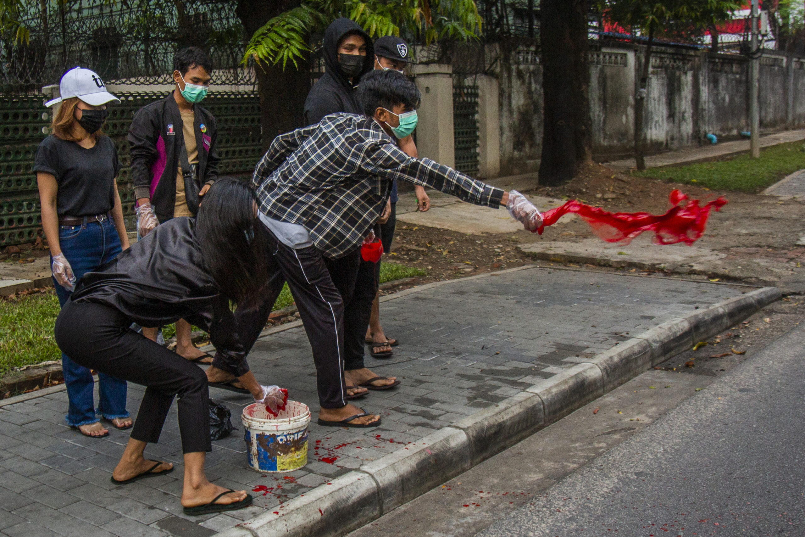 Anti-coup protesters throw red paint on a street during a demonstration in Yangon, Myanmar, Tuesday April 6, 2021. Photo: AP