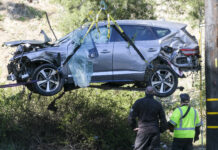 Tiger Woods Was Driving More Than 80 Mph When He Crashed SUV FILE - In this Feb. 23, 2021, file photo, a crane is used to lift a vehicle following a rollover accident involving golfer Tiger Woods, in the Rancho Palos Verdes suburb of Los Angeles. Photo: Ringo H.W. Chiu / AP File
