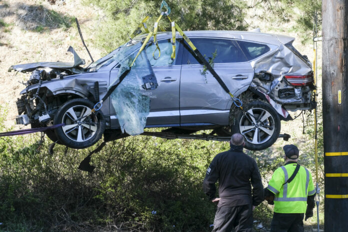 FILE - In this Feb. 23, 2021, file photo, a crane is used to lift a vehicle following a rollover accident involving golfer Tiger Woods, in the Rancho Palos Verdes suburb of Los Angeles. Photo: Ringo H.W. Chiu / AP File