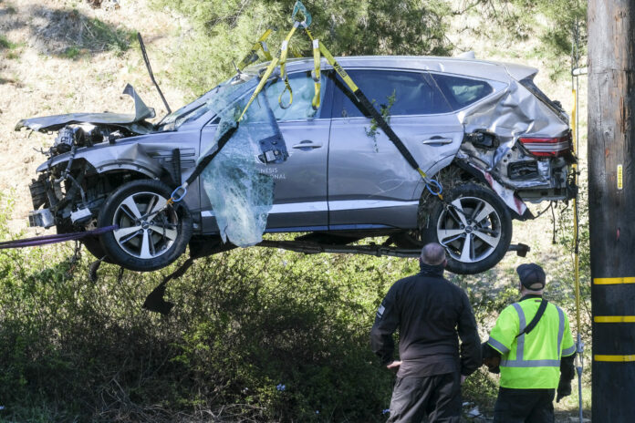 FILE - In this Feb. 23, 2021, file photo, a crane is used to lift a vehicle following a rollover accident involving golfer Tiger Woods, in the Rancho Palos Verdes suburb of Los Angeles. Photo: Ringo H.W. Chiu / AP File FILE - In this Feb. 23, 2021, file photo, a crane is used to lift a vehicle following a rollover accident involving golfer Tiger Woods, in the Rancho Palos Verdes suburb of Los Angeles. Photo: Ringo H.W. Chiu / AP File