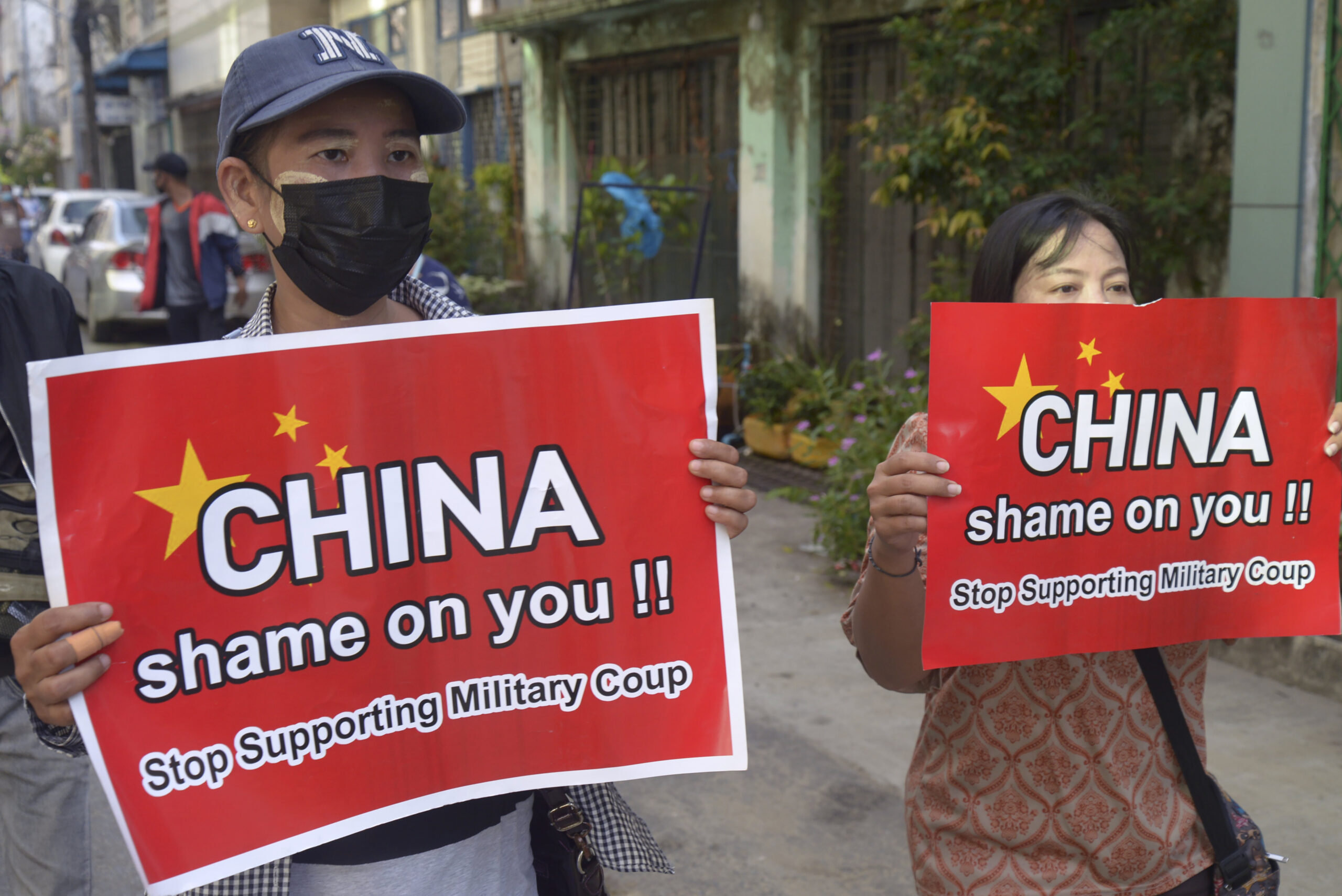 Anti-coup protesters hold slogans against China during a demonstration in Yangon, Myanmar on Wednesday April 7, 2021. Photo: AP