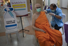Thailand Faces Growing Outbreak Ahead of New Year Travel A health worker administers a dose of the AstraZeneca COVID-19 vaccine to a Buddhist monk at Nak Prok Temple in Bangkok, Thailand, Friday, April 9, 2021. Photo: Sakchai Lalit / AP