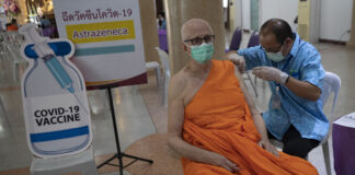 Thailand Faces Growing Outbreak Ahead of New Year Travel A health worker administers a dose of the AstraZeneca COVID-19 vaccine to a Buddhist monk at Nak Prok Temple in Bangkok, Thailand, Friday, April 9, 2021. Photo: Sakchai Lalit / AP