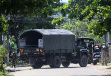 Reports: Myanmar Forces Kill 82 in Single Day in City A police vehicle is parked at a road in South Okkalapa township to block anti-coup protesters' gathering in Yangon, Myanmar, Friday, April 9, 2021. Photo: AP