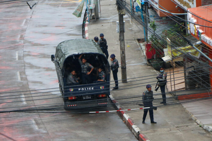 Police security forces stand by inside a police vehicle and on the sidewalk of Hledan Road in Kamayut township in Yangon, Myanmar Friday, April 16, 2021. Photo: AP Police security forces stand by inside a police vehicle and on the sidewalk of Hledan Road in Kamayut township in Yangon, Myanmar Friday, April 16, 2021. Photo: AP