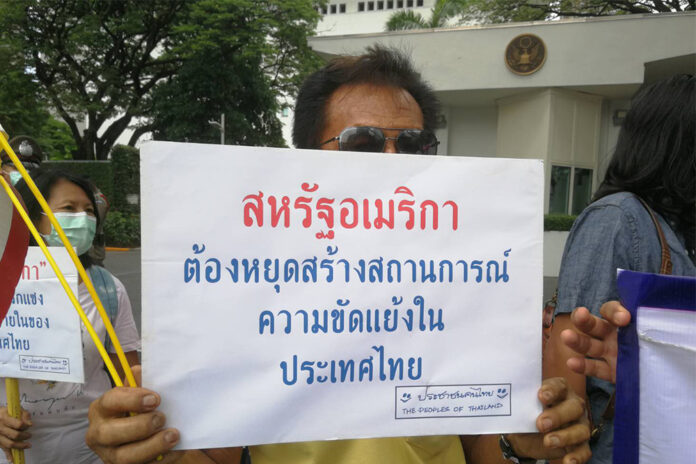 A protester holds up a sign that reads, 