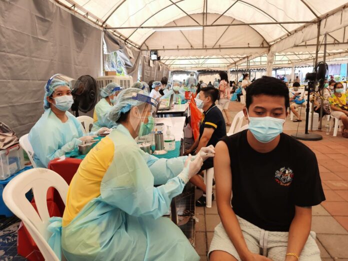 A man receives a dose of COVID-19 vaccine at a vaccination center in Khlong Toey community in Bangkok on May 9, 2021.