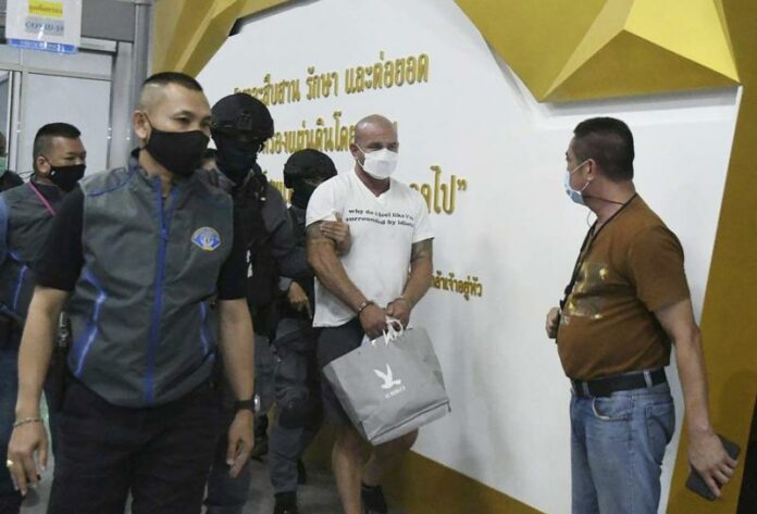 In this Saturday, May 15, 2021, photo, American Louis William Ziskin, center, is escorted by police at the Crime Suppression Division in Bangkok, Thailand. Photo: AP