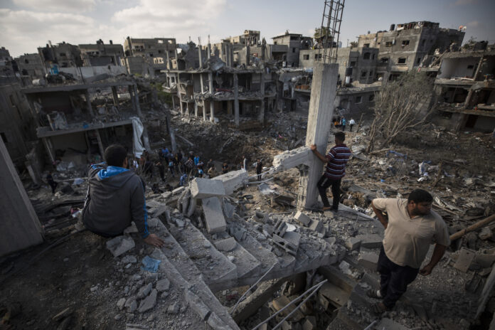 Palestinians inspect their destroyed houses following overnight Israeli airstrikes in town of Beit Hanoun, northern Gaza Strip, Friday, May 14, 2021. Photo: Khalil Hamra / AP Palestinians inspect their destroyed houses following overnight Israeli airstrikes in town of Beit Hanoun, northern Gaza Strip, Friday, May 14, 2021. Photo: Khalil Hamra / AP