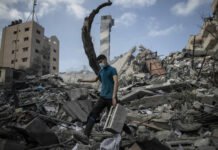 Israeli Police: 2 Thais Killed in Strike Launched From Gaza A Palestinian man inspects the damage of a six-story building which was destroyed by an early morning Israeli airstrike, in Gaza City, Tuesday, May 18, 2021. Photo: Khalil Hamra / AP