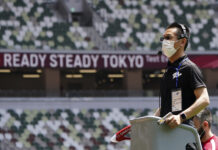Japan’s Vaccine Push Ahead of Olympics Looks To Be Too Late An official wears a face mask as he uses a starter pistol to signal the start a women's 100 meter heat at an athletics test event for the Tokyo 2020 Olympics Games at National Stadium in Tokyo, Sunday, May 9, 2021. Photo: Shuji Kajiyama / AP