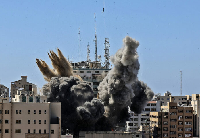 FILE - In this Saturday, May 15, 2021, file photo, an air bomb hits the building housing various international media, including The Associated Press, in Gaza City. Photo: Mahmud Hams / Pool Photo via AP File