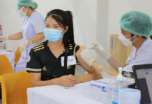 Officials Deny Vaccine Shortage for Delay of Private Employee Inoculations A woman receives a shot of COVID-19 vaccine at a vaccination center at Bangkok Bank Sport Club in Bangkok on June 10, 2021.