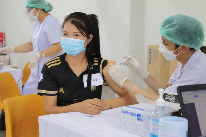 A woman receives a shot of COVID-19 vaccine at a vaccination center at Bangkok Bank Sport Club in Bangkok on June 10, 2021.