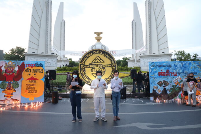 Protest leader Arnon Nampa and others read out the People Party's Declaration proclaiming the end of absolute monarchy during a rally marking the 89th anniversary of the 1932 coup at the Democracy Monument on June 24, 2021.