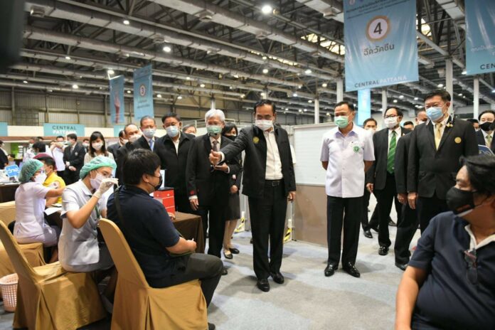 PM Prayut Chan-o-cha raises his thumb to a man who is receiving a COVID-19 vaccine at Central Plaza Ladprao mall on May 12, 2021. PM Prayut Chan-o-cha raises his thumb to a man who is receiving a COVID-19 vaccine at Central Plaza Ladprao mall on May 12, 2021.
