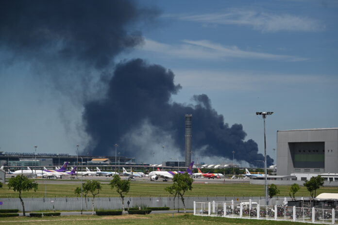 Smoke rises into the air from a factory in Samut Prakan province, Thailand, Monday, July 5, 2021.