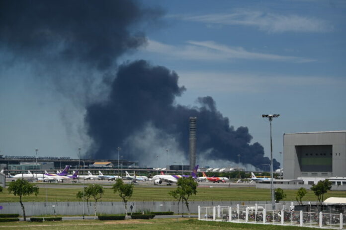 Smoke rises into the air from a factory in Samut Prakan province, Thailand, Monday, July 5, 2021.