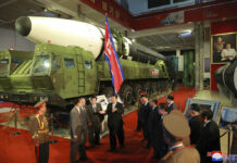 North Korea Fires Suspected Ballistic Missile Into Sea In this photo provided by the North Korean government, North Korean leader Kim Jong Un, center, speaks in front of what the North says an intercontinental ballistic missile displayed at an exhibition of weapons systems in Pyongyang, North Korea, Monday, Oct. 11, 2021. Independent journalists were not given access to cover the event depicted in this image distributed by the North Korean government. The content of this image is as provided and cannot be independently verified. Korean language watermark on image as provided by source reads: "KCNA" which is the abbreviation for Korean Central News Agency. Photo: Korean Central News Agency / Korea News Service via AP