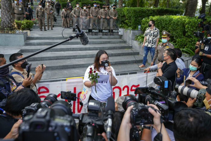 Pro-democracy activist Panusaya Sithijirawattanakul talks to the media after leaving the Constitutional Court where her protest activities came under legal review in Bangkok, Thailand, Wednesday, Nov. 10, 2021. Photo: Sakchai Lalit / AP