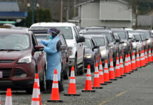 Fauci: COVID Case Counts May Be Losing Importance Amid Omicron A worker at a drive-up COVID-19 testing clinic administers PCR coronavirus tests, Tuesday, Jan. 4, 2022, in Puyallup, Wash., south of Seattle. Photo: Ted S. Warren / AP
