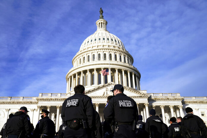A large group of police arrive at the Capitol, Thursday, Jan. 6, 2022, in Washington. Photo: Evan Vucci / AP