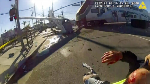 In this screen grab from a body cam video provided by the Los Angeles Police Department, a commuter train crashes with a plane which had just taken off from nearby Whiteman Airport Sunday, Jan. 9, 2021 in Pacoima, Calif. Photo: Los Angeles Police Department via AP