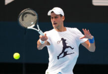 Djokovic Back Into Swing in Australia, Visa Questions Linger In this photo supplied by Tennis Australia, defending champion Serbia's Novak Djokovic practices in the Rod Laver Arena ahead of the Australian Open at Melbourne Park in Melbourne, Australia, Tuesday, Jan. 11, 2022. Photo: Scott Barbour / Tennis Australia via AP