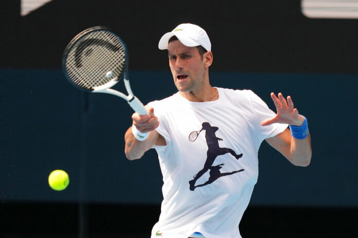 In this photo supplied by Tennis Australia, defending champion Serbia's Novak Djokovic practices in the Rod Laver Arena ahead of the Australian Open at Melbourne Park in Melbourne, Australia, Tuesday, Jan. 11, 2022. Photo: Scott Barbour / Tennis Australia via AP