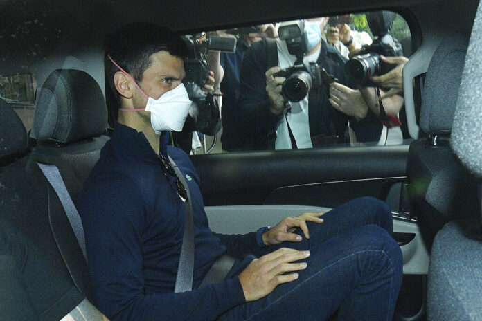 Serbian tennis player Novak Djokovic rides in car as he leaves a government detention facility before attending a court hearing at his lawyers office in Melbourne, Australia, Sunday, Jan. 16, 2022. Photo: James Ross / AAP via AP