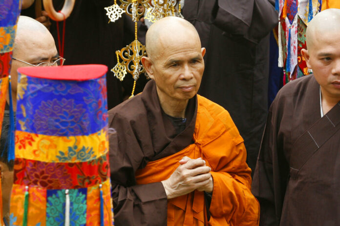 FILE - Vietnamese Zen master Thich Nhat Hanh, center, arrives for a great chanting ceremony at Vinh Nghiem Pagoda in Ho Chi Minh City, Vietnam on March 16, 2007. Photo: AP File