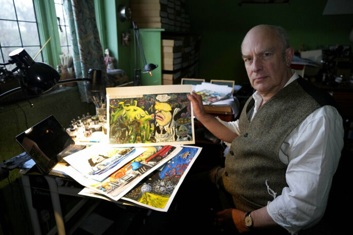 Martin Rowson shows Britain's Prime Minister Boris Johnson cartoons as he poses for a photographer in his studio in London, Monday, Jan. 24, 2022. Photo: Frank Augstein / AP