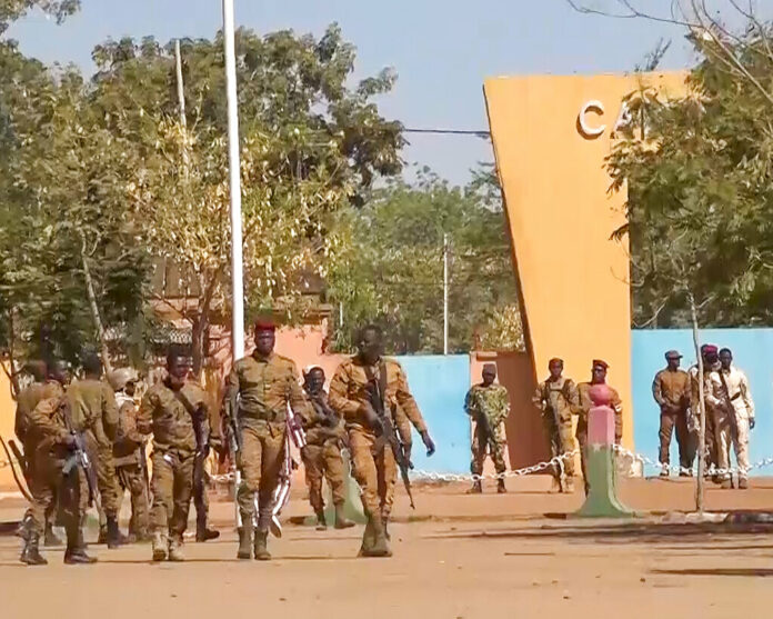 In this image made from video, Burkina Faso mutinous soldiers walk outside the Guillaume Ouedraogo military camp in Ouagadougou, Monday Jan. 24, 2022. Photo: AP In this image made from video, Burkina Faso mutinous soldiers walk outside the Guillaume Ouedraogo military camp in Ouagadougou, Monday Jan. 24, 2022. Photo: AP