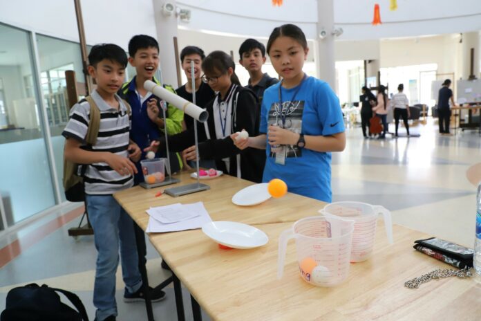 A file photo of students participating in a science experiment at Thammasat Secondary School.