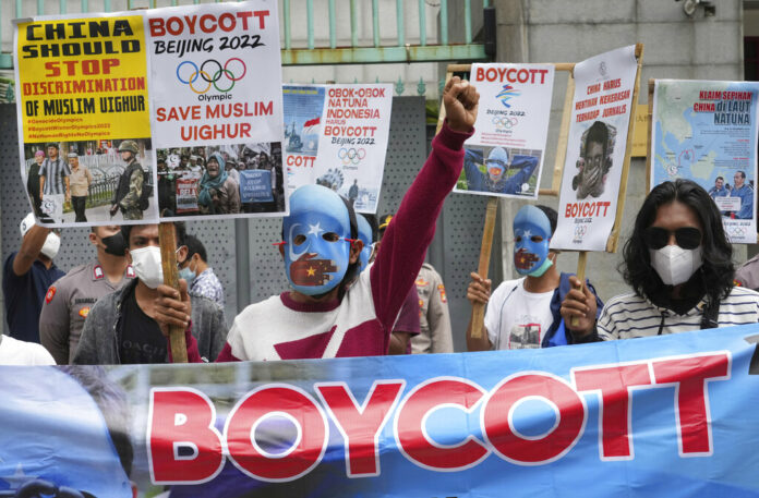FILE - Student activists, some wearing masks with the colors of the pro-independence East Turkistan flag, shout slogans during a rally to protest the Beijing 2022 Winter Olympic Games, outside the Chinese Embassy in Jakarta, Indonesia on Jan. 14, 2022. Photo: Tatan Syuflana / AP File FILE - Student activists, some wearing masks with the colors of the pro-independence East Turkistan flag, shout slogans during a rally to protest the Beijing 2022 Winter Olympic Games, outside the Chinese Embassy in Jakarta, Indonesia on Jan. 14, 2022. Photo: Tatan Syuflana / AP File