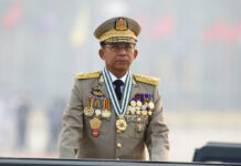 Dozens Arrested To Suppress Protests on Myanmar Anniversary Myanmar's Commander-in-Chief Senior General Min Aung Hlaing presides an army parade on Armed Forces Day in Naypyitaw, Myanmar, Saturday, March 27, 2021. Photo: AP