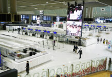Japan Border Policy Keeps Thousands of Foreigners in Limbo FILE - Passengers walk through the ticketing counter floor for international flights at the Narita International Airport in Narita, east of Tokyo, on Dec. 2, 2021. Photo: Hiro Komae / AP File