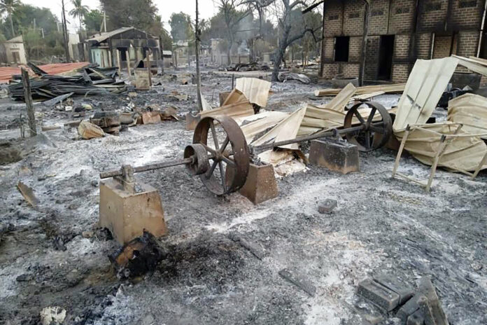 Charred homes sit in piles of ash in Mwe Tone village of Pale township in the Sagaing region, Myanmar, Tuesday, Feb. 1, 2022. Photo: AP