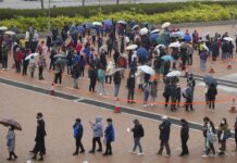 Across Asia, Spike in Virus Cases Follows Lunar New Year Residents line up to get tested for the coronavirus at a temporary testing center for COVID-19 in Hong Kong Monday, Feb. 7, 2022. Photo: Vincent Yu / AP