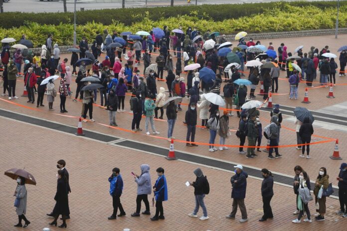 Residents line up to get tested for the coronavirus at a temporary testing center for COVID-19 in Hong Kong Monday, Feb. 7, 2022. Photo: Vincent Yu / AP Residents line up to get tested for the coronavirus at a temporary testing center for COVID-19 in Hong Kong Monday, Feb. 7, 2022. Photo: Vincent Yu / AP