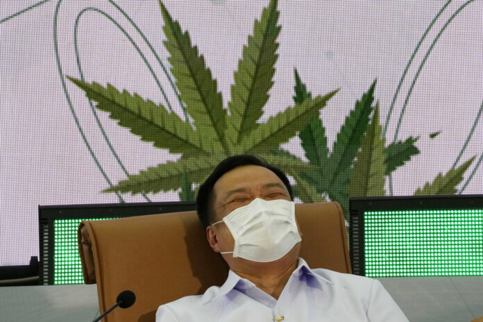 Public Health Minister Anutin Charnvirakul reacts during news conference Tuesday, Feb. 8, 2022, at the Public Health Ministry in Nonthaburi, Thailand, after signing a measure that drops cannabis from his ministry's list of controlled drugs. Photo: Sakchai Lalit / AP