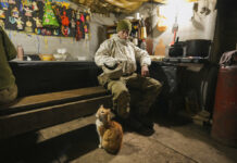 Ukrainians Not Panicking as West Ramps up Invasion Rhetoric Good luck charms are pinned to a wall as a Ukrainian serviceman pauses in a bunker on a frontline position outside Avdiivka, Donetsk region, eastern Ukraine, Friday, Feb. 4, 2022. Photo: Vadim Ghirda / AP